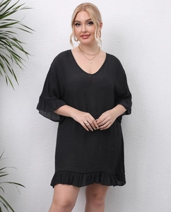 Detail of plus size black beach cover-up featuring V-neckline and ruffled hems on white background