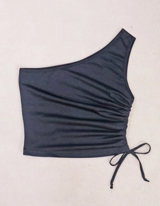 Detailed view of black one-shoulder crop top with drawstring ruching and tie design