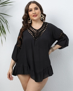 Detail of the black crochet hollow embroidery and ruffled hem on this plus size beach cover-up
