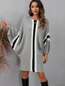 Detail of grey knitted midi dress featuring striped contrast sleeves and a loose fit cut