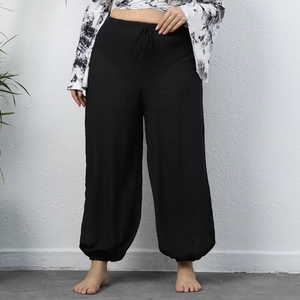 Detail of black cotton linen lantern pants with high waist drawstring and elastic cuffs