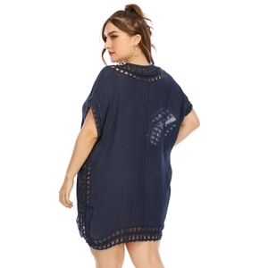 Detail of navy crochet seaside cover-up showing side cut-outs and lace trimming
