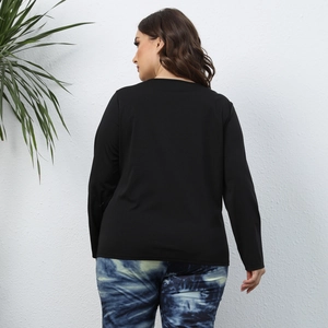 Back view of women's black long sleeve t-shirt and tie-dye slim pants in home setting