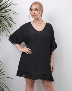 Detail of plus size black V-neck dress with ruffle hem and lightweight woven fabric texture