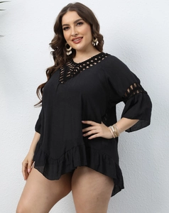 Detail of black crochet hollow-out lace and ruffled hem on a bohemian beach cover-up