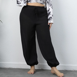 Detail of plus size black beach pants featuring elastic drawstring waist and cuffed hem