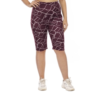 Detail of high-waisted burgundy yoga shorts with white geometric pattern on model