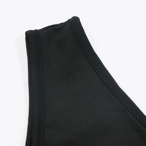 Close-up of black knitted fabric with reinforced double-stitch edging and refined texture