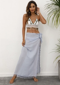 Boho beach set with crochet halter top shell tassels and blue wrap skirt on model