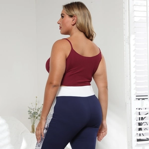 Women's two-piece yoga set with ribbed burgundy crop top and blue high-waist leggings