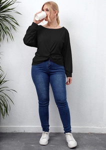 Detail of plus size black long sleeve top featuring a unique front twist knot design