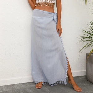Light blue semi-sheer wrap sarong skirt with decorative tassels for beach vacations