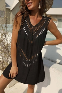 Detailed close-up of bohemian crochet knit texture on a black V-neck beach cover-up dress