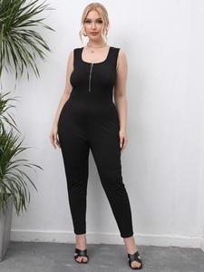 Close-up of black sleeveless jumpsuit showing silver ring zipper and ribbed texture