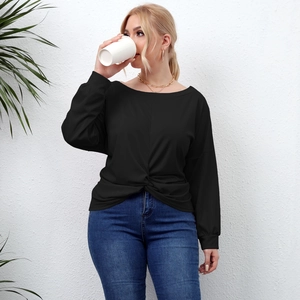 Detail of black long sleeve top featuring unique crisscross knot design and round neckline