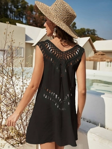 Detail of crochet hollow-out back design on a black V-neck beach cover-up dress