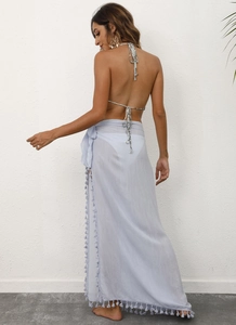 Detail of light blue wrap sarong featuring long tassels for beachwear fashion
