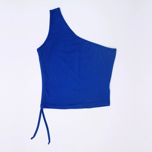 Detail of royal blue one-shoulder crop top featuring adjustable side drawstring ties