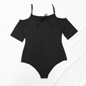 Detail of black ribbed bodysuit featuring cold shoulder straps and front tie bow detail