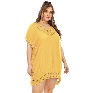 Close-up of crochet lace trim and V-neckline on a yellow boho plus size beach cover-up