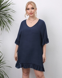 Close-up of navy blue V-neck dress featuring ruffled sleeves and textured fabric