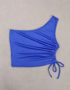 Close-up of bright blue one-shoulder crop top with drawstring ruching detail