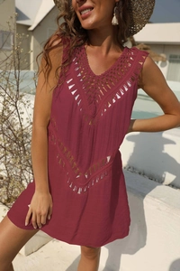 Detail of burgundy crochet hollow-out dress with geometric patterns and V-neck design