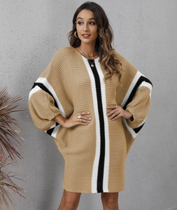 Detail view of khaki knit dress featuring loose batwing sleeves and striped patchwork texture