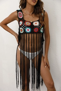 Détail du haut de plage au crochet noir avec fleurs colorées et longues franges fluides