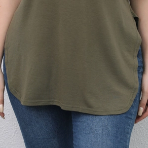 Detail of army green short sleeve tee with curved hem and classic blue denim jeans