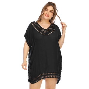 Close-up of black beach cover-up featuring intricate crochet lace detail on the V-neckline