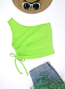 Close-up of fluorescent green one shoulder crop top with adjustable side drawstring detail
