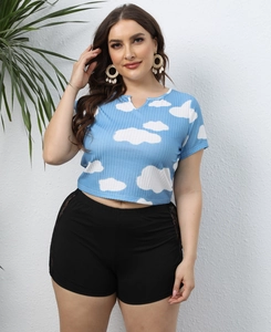 Detail showing white cloud print on sky blue ribbed fabric and lace-up hem of the short top