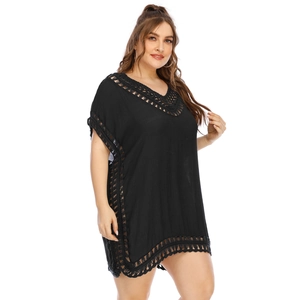 Detail of the black V-neck beach cover-up featuring intricate crochet lace and textured fabric