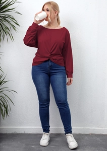 Detail of plus size wine red long sleeve top featuring a unique front twist knot design