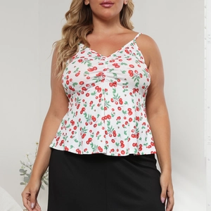 Detail of plus size white camisole featuring red cherry print and ribbed fabric texture