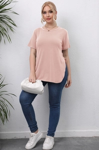 Detail view of the curved side slit hem on a mauve plus-size casual crew neck T-shirt