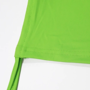 Detail of bright green tight top showing double-needle wavy stitching and elastic fabric