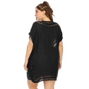 Detail of black crochet trim and sheer fabric on back of beach dress cover-up