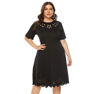 Close-up of laser-cut floral hollow details on a black plus size short sleeve dress
