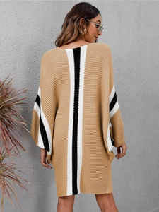 Close-up of knit dress back with black and white vertical stripes and batwing sleeves