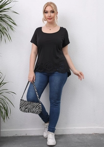 Close-up of laser-cut floral hollow pattern and scalloped hem on black plus size T-shirt