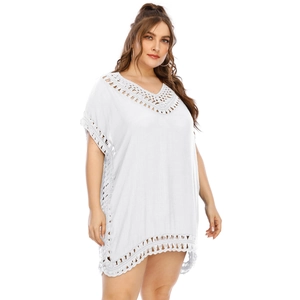 Detailed view of the bohemian hollow lace crochet on a white V-neck beach cover up dress