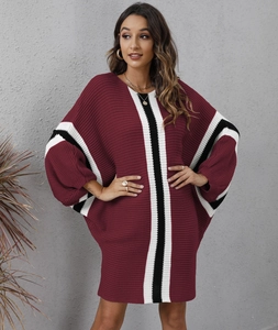 Detail of burgundy knitted dress with batwing sleeves and vertical black and white stripes