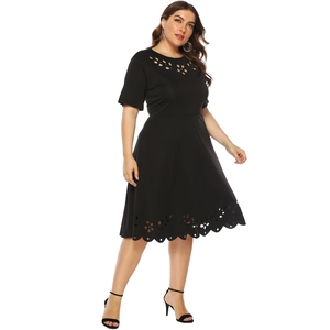 Detail showing laser-cut floral cutouts and textured fabric on plus size black dress