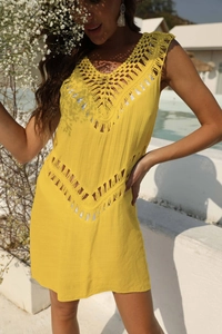 Close-up of yellow crochet V-neck beach cover-up showing intricate geometric lace details