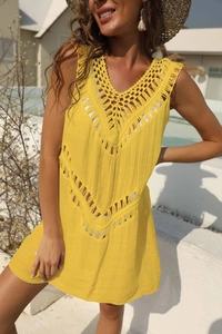 Detailed crochet knitting and fringe on a yellow V-neck beach cover-up dress