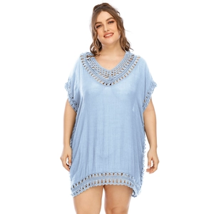 Close-up of light blue crochet V-neck beach dress with elegant hollow lace detail