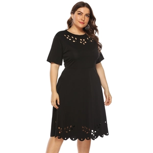 Detail of laser-cut floral patterns on the black short-sleeve A-line plus size dress