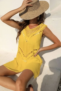 Detail of crochet v-neck and hollow lace pattern on bright yellow beach cover-up